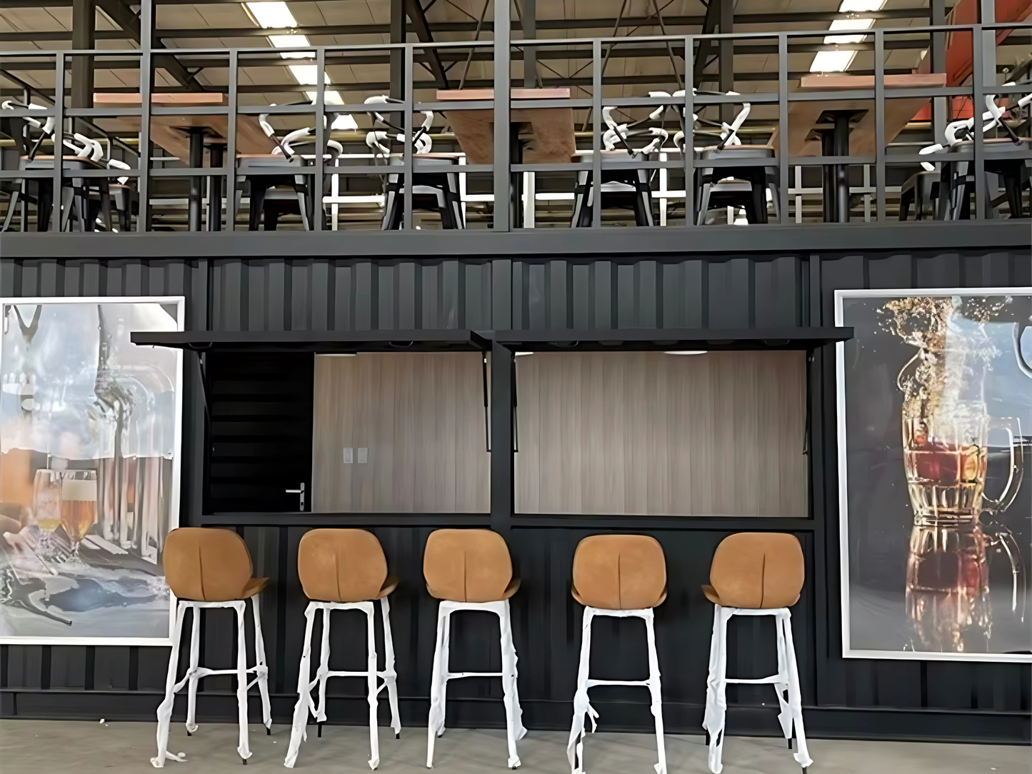 Container bar area with stools and wall art in a modern interior setting