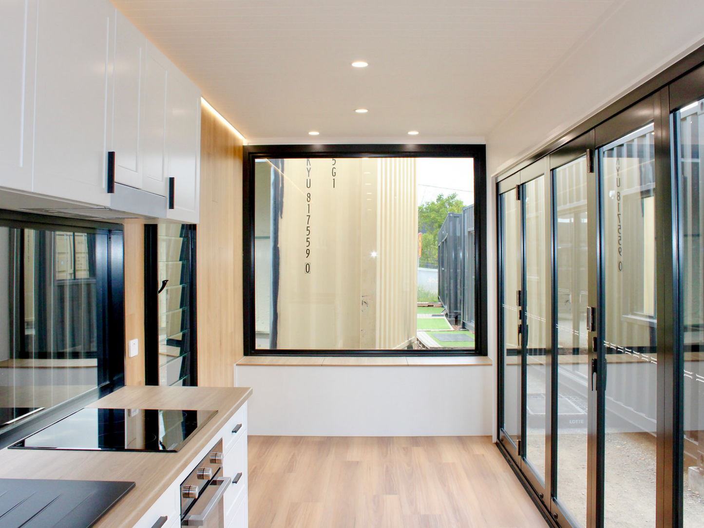 Modern kitchen with black-framed window and sliding glass door