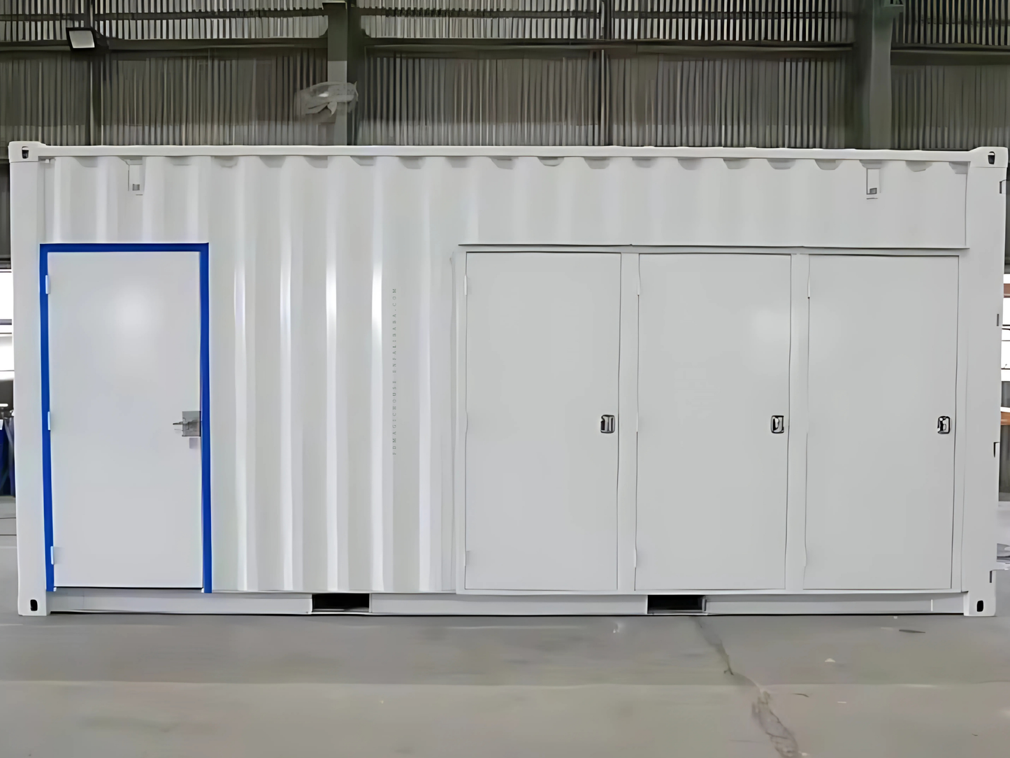 A white shipping commercial container unit with a blue door in a warehouse setting