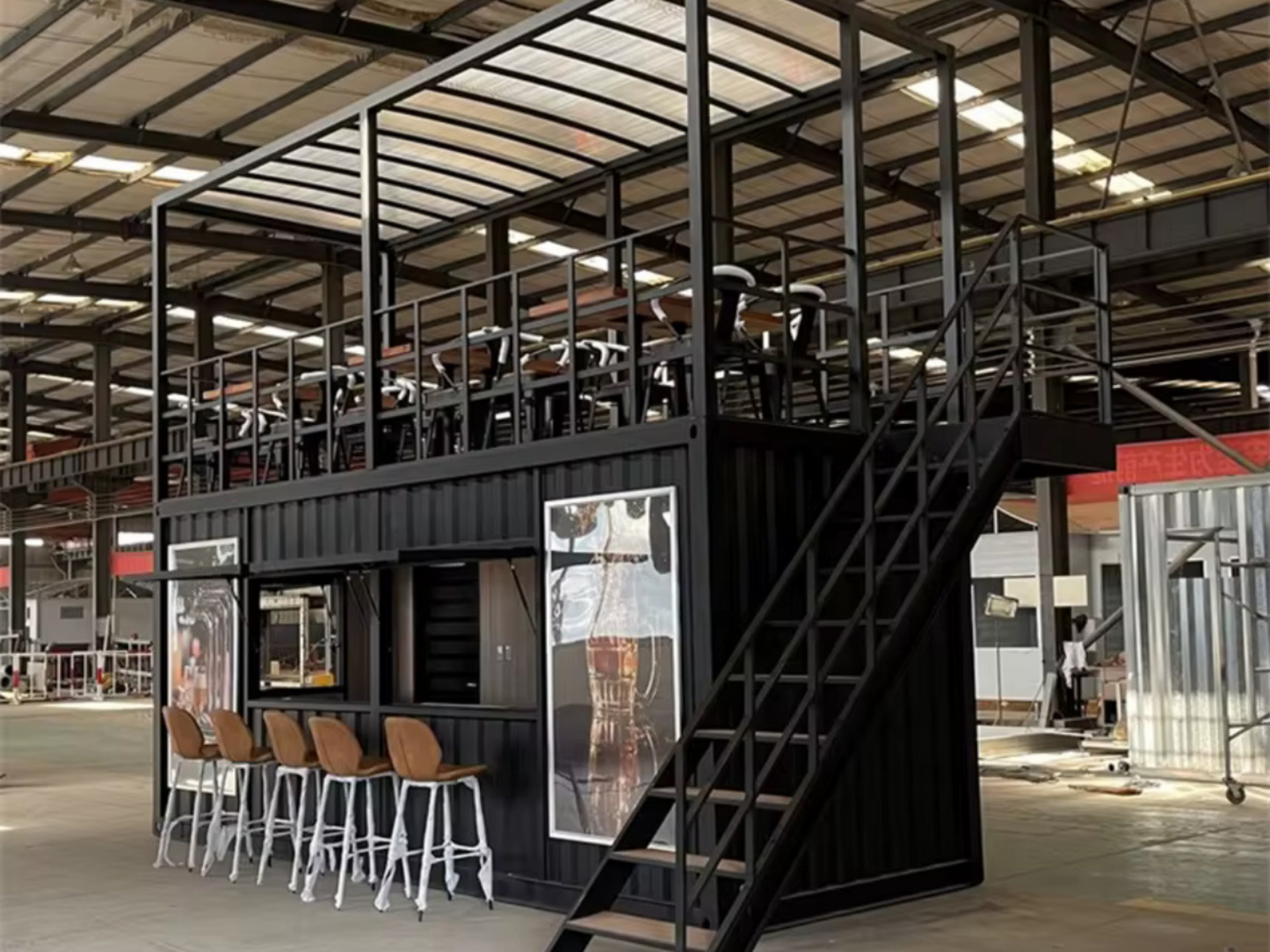 Modern industrial interior with metal container architecture and loft area.