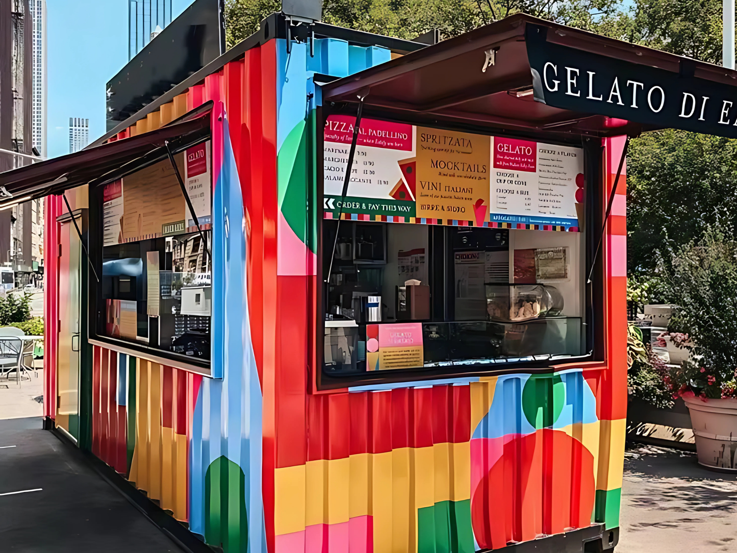 Colorful food container with 'Gelato Di E' branding in an urban setting.