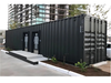 Container modular bathroom facility made from shipping containers with 'Artisan' branding.