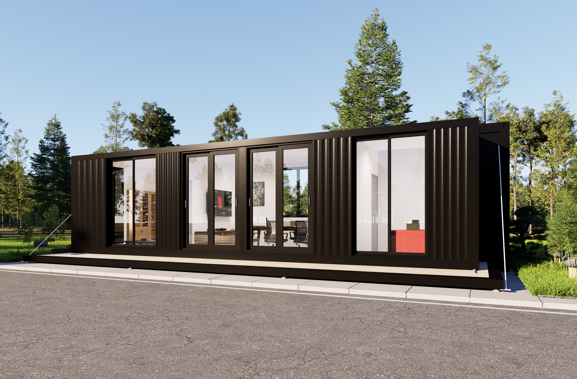 Modular building made from shipping containers with large windows, set against a clear blue sky.