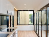 Modern kitchen with black-framed window and sliding glass door