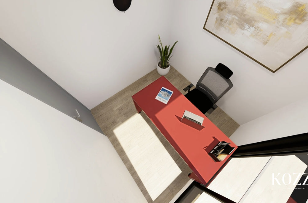 Modern office desk with red surface, black chair, and decor elements.