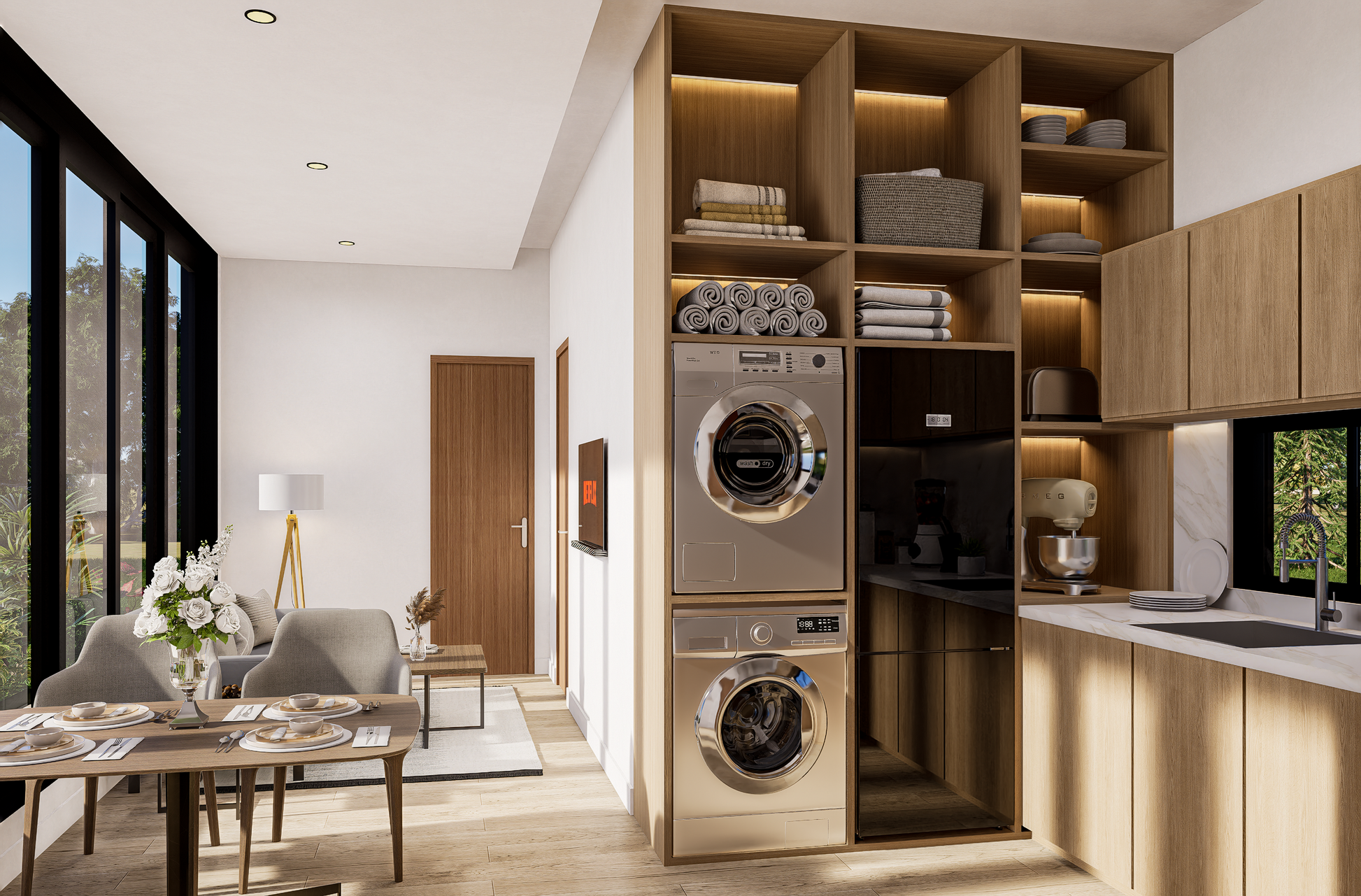 Modern kitchen with built-in washer and dryer, dining area, and large windows.