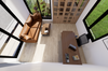 Modern office interior with a desk, chair, and sofa near large windows.