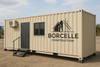 Beige modular building with Borcelle Construction logo on a clear day.