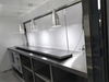 Modern kitchen with stainless steel appliances and a large mirror.