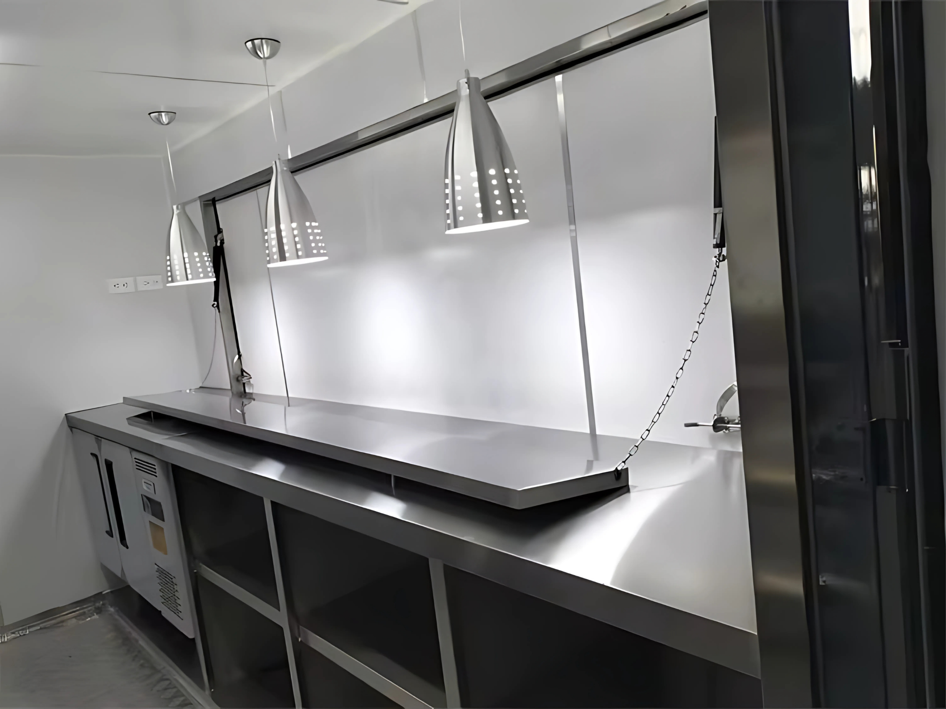 Modern kitchen with stainless steel appliances and a large mirror.