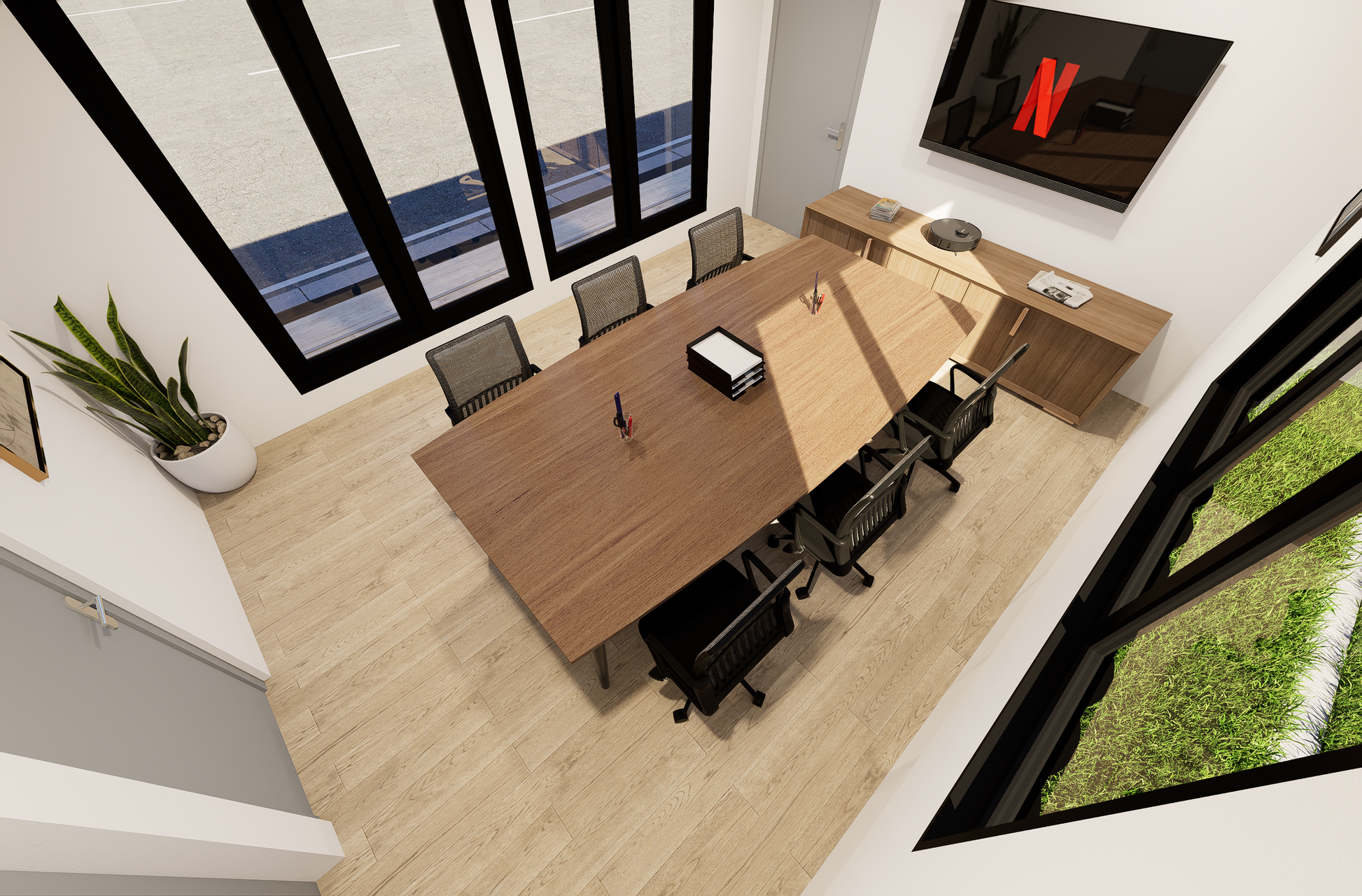 Modern office conference room with wooden table, chairs, and a TV displaying a logo.