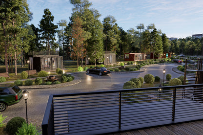Gated community with cars, pathways, and greenery. All homes are made with shipping containers. 