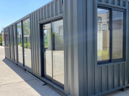 Modular building with glass walls and metal frame on a clear day