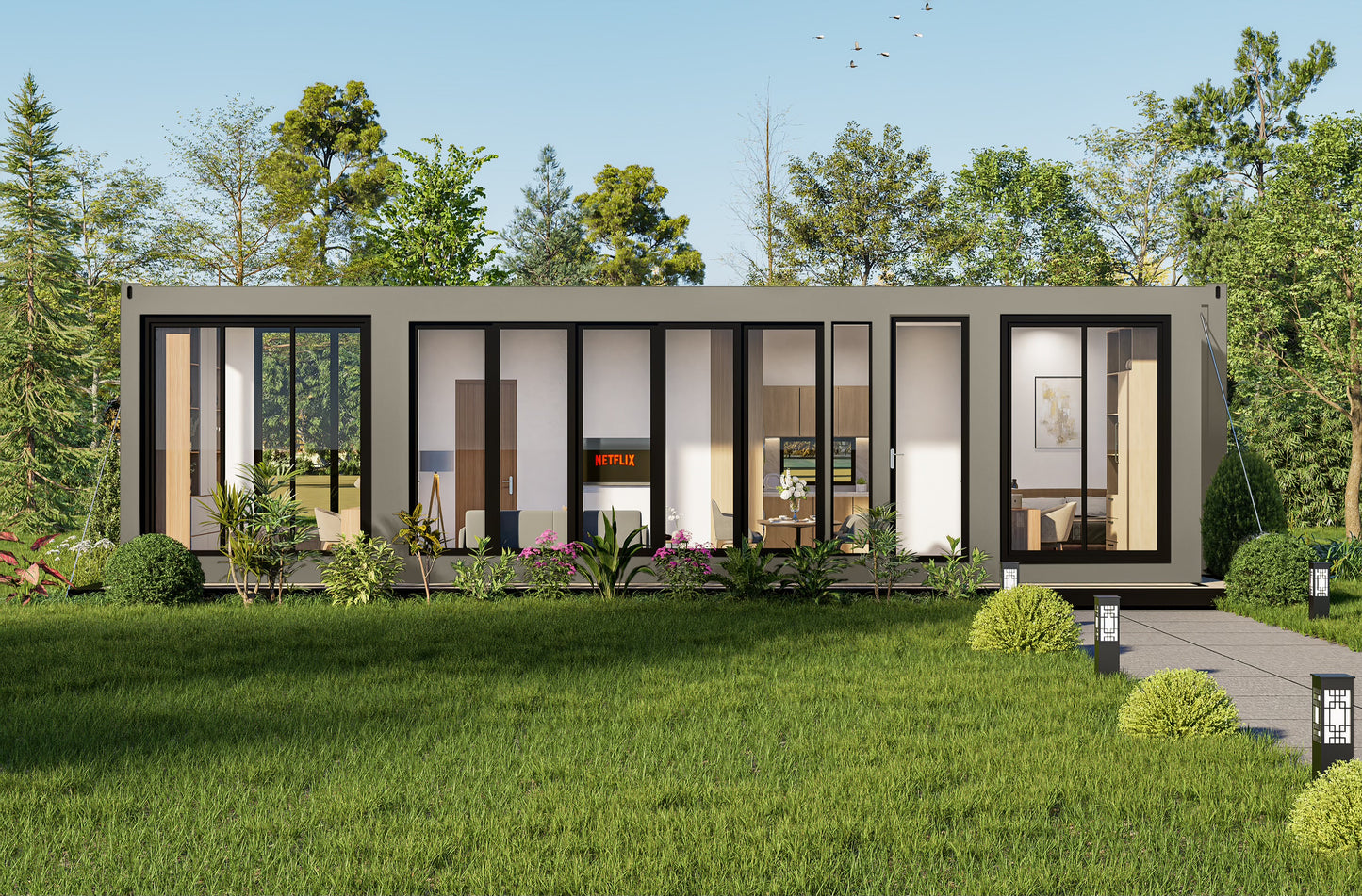 Modern container modular building with glass windows in a green outdoor setting