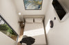 Small bedroom with a bed, side table, and wall art.