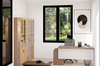 Modern office space with a desk, chair, and large window overlooking greenery.