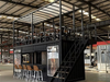 Modern industrial interior with container shop and loft area.