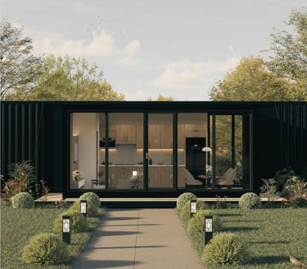 Modern house with large glass windows surrounded by greenery